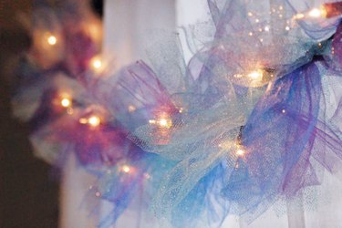 Tie strips of mesh ribbon around a strand of string lights to create a whimsical lighted garland.