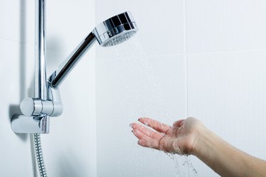 Hand under shower spray