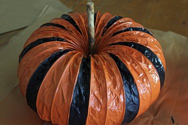 Place a stick in the center of the pumpkin