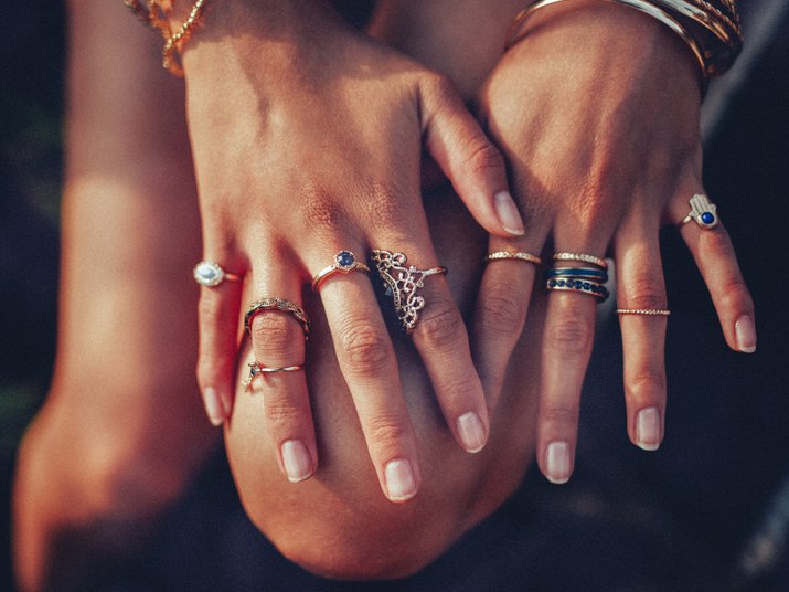 Boho girl\'s hands looking feminine with many rings
