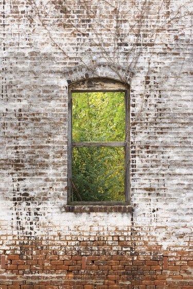 Window frame in decaying brick wall
