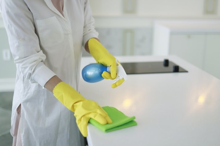 Woman cleaning kitchen counter