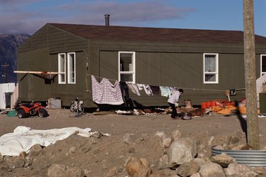 Woman doing laundry outside trailer home