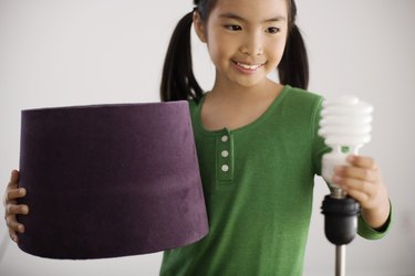 Girl holding lamp with CFB