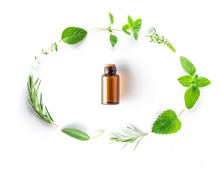 High Angle View Of Bottle With Herbs Arranged On White Background