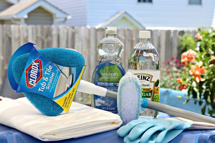 Tub and tile scrubber, dish soap and vinegar are used to freshen outdoor trash cans