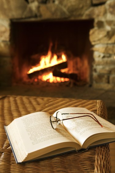 Glasses and book near fireplace