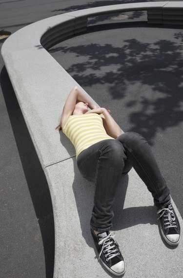 woman lying on the pavement