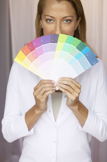 Woman Displaying a Variety of Paint Samples