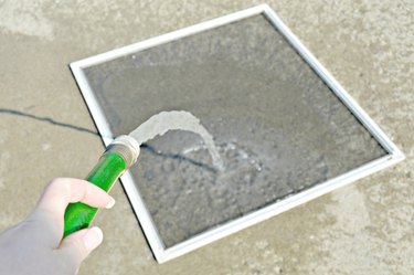 Use water hose to wet window screen well