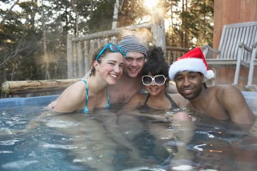Young people in hot tub posing for portrait