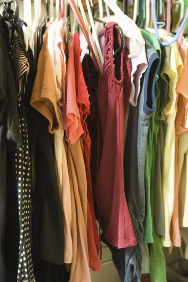 Clothes hanging in woman\'s closet