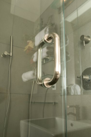 Glass shower door with stainless steel handle