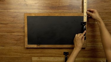 Marking placement of front-mounting cabinet pulls for DIY chalkboard serving tray.
