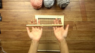 Using a dowel shed stick for an easy DIY woven wall hanging.