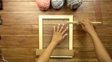 Using a dowel shed stick for an easy DIY woven wall hanging.