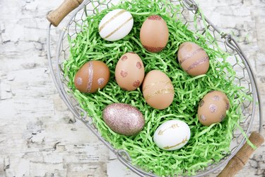Basket of eggs decorated with glitter.