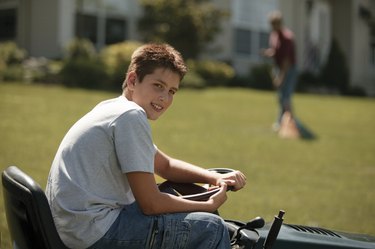 Boy on lawn mower