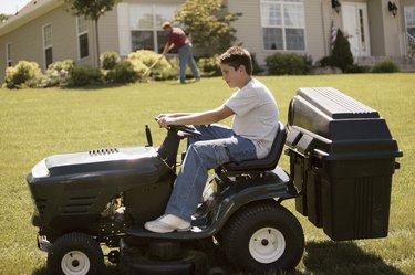 Boy on tractor mower
