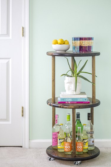 Learn how to make your own solid wood rolling bar cart.