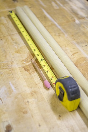 Mark the dowel rods using a ruler or measuring tape.