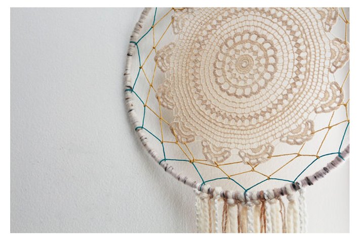 lace doily dreamcatcher hanging on wall