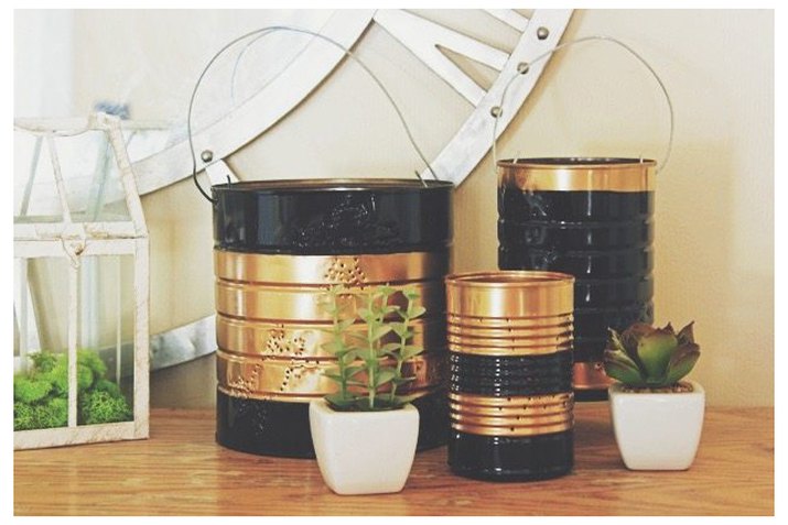 black and gold tin can lanterns on a shelf