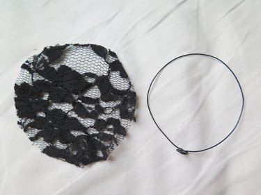 The cut lace circle next to the wire ear.