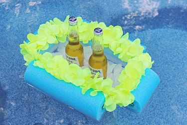 beverage boat floating in a pool with two beers