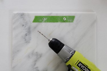 Drill holes through the marble at the marks