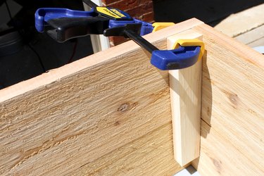 using 2 clamps attach a 9" wood slat | how to make an elevated planter box