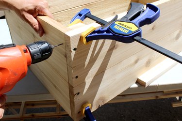 drill pilot hole and deck screws to attach 9" wood slat | how to make an elevated planter box