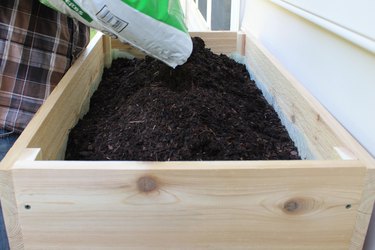 add gardening soil to box and favorite plants | how to make an elevated planter box