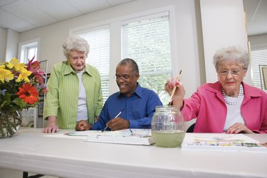 Elderly people painting with watercolors