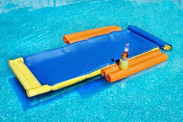 floating lounge chair in the pool with a beer in cup holder