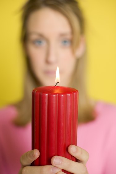 Woman holding lit candle